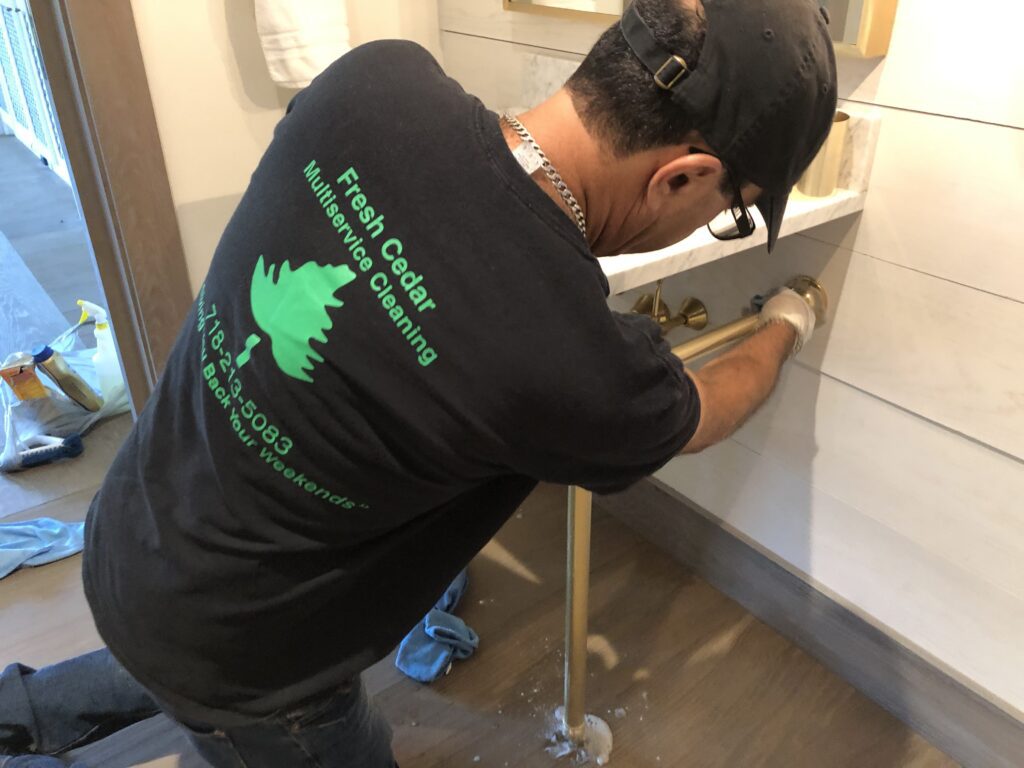 Man cleaning a machine while wearing a black shirt